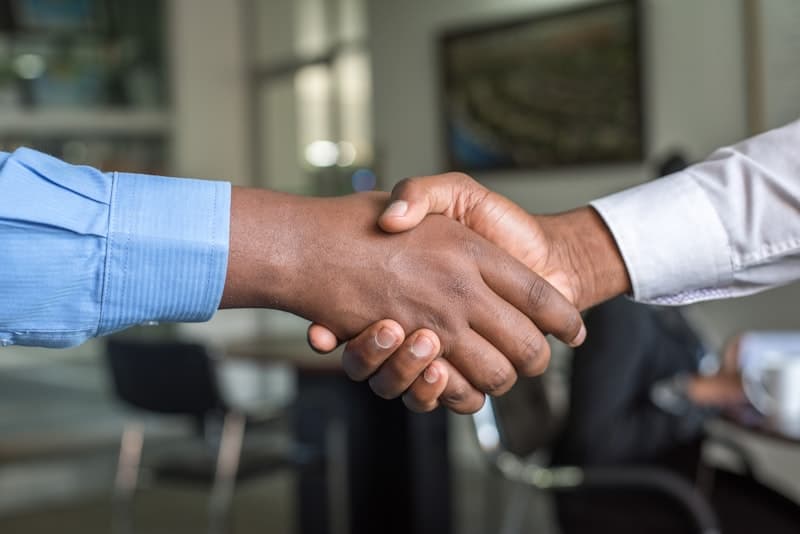 Business partners shaking hands - representing successful sports sponsorship partnerships