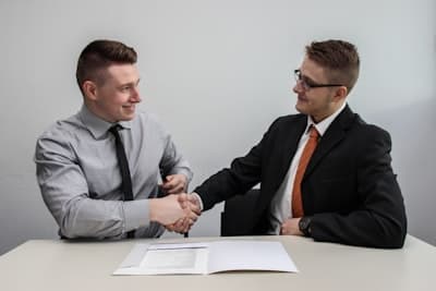Business partnership handshake - Tech Solutions Ltd success story